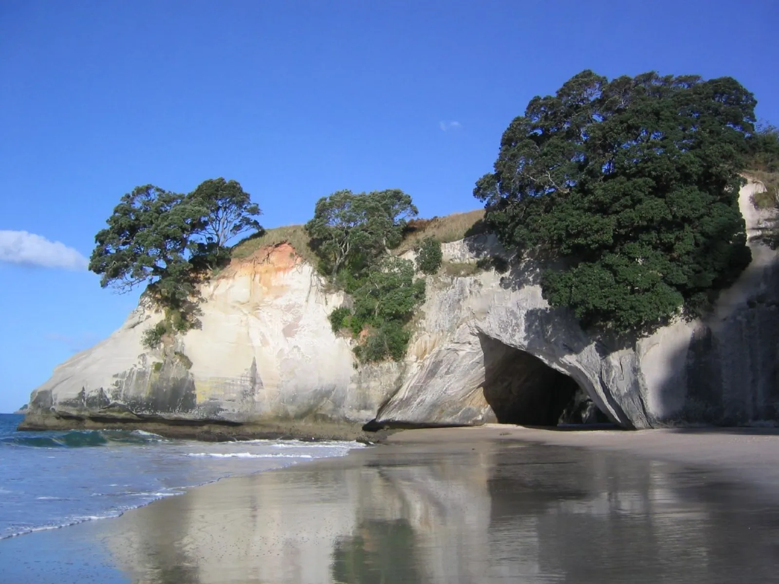 Rugged Coromandel Peninsula coastline under changeable New Zealand weather
