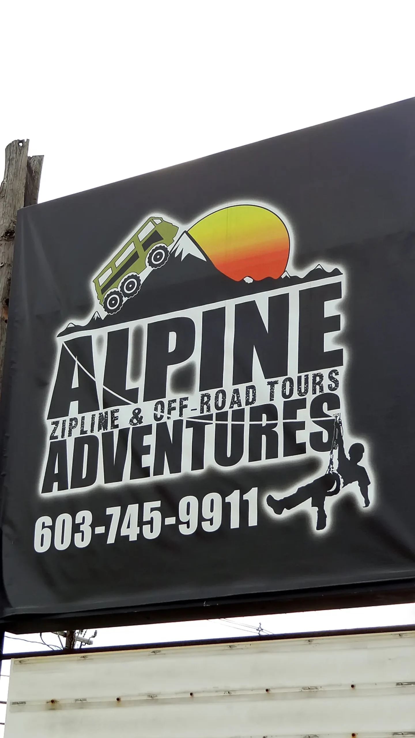 A person ziplining through a forest canopy on a flying fox, similar to the Coromandel canopy tour