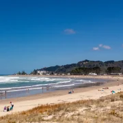 Wide sandy Whangamata surf beach on the Coromandel Peninsula, a popular dog-walking spot
