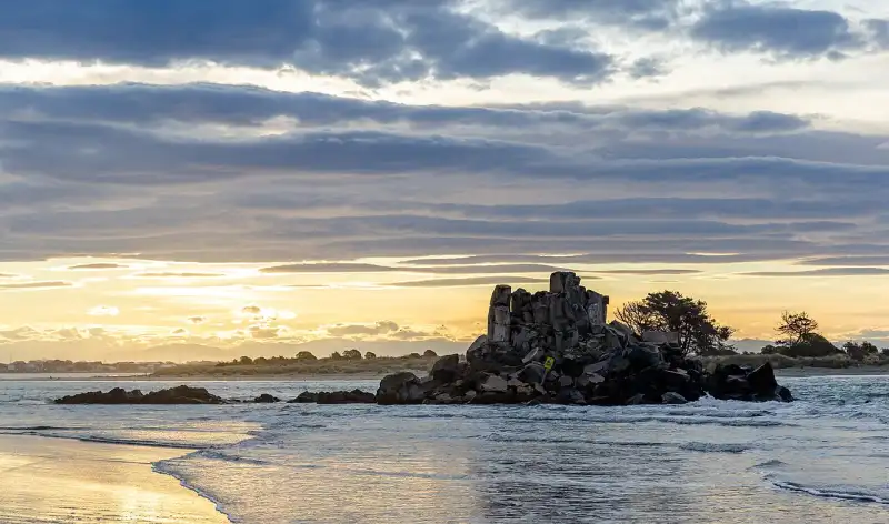 Dramatic sunset over coastal rocks in New Zealand